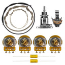 All of the components included in the unassembled SG wiring kit. This includes parts such as CTS 500K vintage taper short shaft 7% tolerance potentiometers, a Switchcraft short straight toggle switch, a Switchcraft mono input jack, Mojotone dijon .022uF capacitors, one foot of pre-tinned cloth covered wire in black, one foot of bus wire, and one foot of shielded cloth covered 22 gauge black wire.