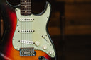 Close-up of a electric guitar with a sunburst finish on a blurred background
