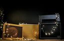 Vintage amplifiers with string lights against a dark background