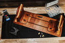 Wooden tool bench with various tools on a wooden surface